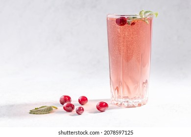 Glass Of Seltzer Water With Cranberries And Mint Leaf