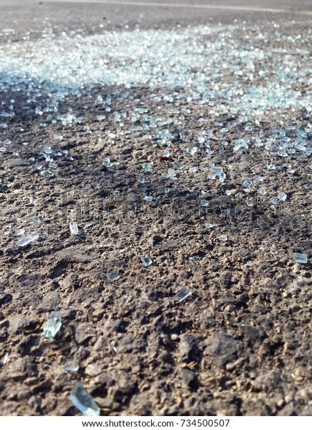 Glass shards Scattered On The Road Sparkling In The\
Sunlight - Close Up