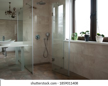 Glass Shower Cubicle And Vintage Chandelier In The Bathroom