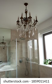 Glass Shower Cubicle And Vintage Chandelier In The Bathroom