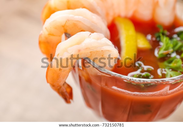 Glass with\
shrimp cocktail and tomato sauce,\
closeup