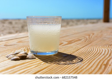 A Glass Of Soda Lemon Water On The Beach.