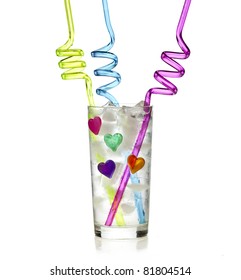 Glass Of Soda Water With Ice Cube And Colorful Curly Drinking Straw Isolated On White