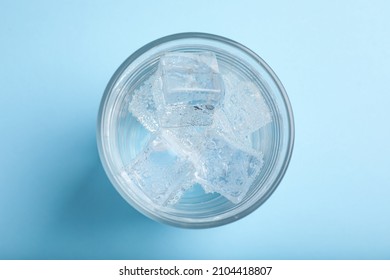 Glass Of Soda Water With Ice On Light Blue Background, Top View