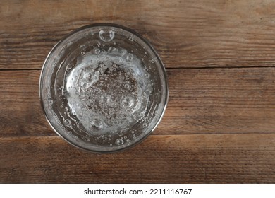 Glass Of Soda Water On Wooden Table, Top View. Space For Text