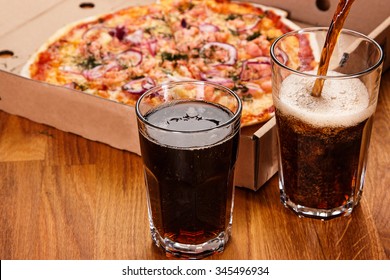 Glass Of Soft Drink And Pizza On The Table