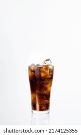 Glass of softdrink with reflection on white background.