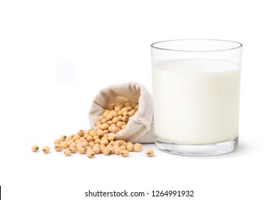 Glass of Soy milk with soybeans in in hemp fabric bag isolated on white background.