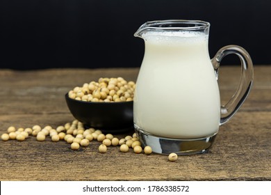 A Glass Of Soymilk With Soybeans On Wooden Table Background.