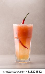 Glass Of Spicy Hot Cocktail Isolated On Grey Background