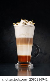 Glass of spicy pumpkin latte on a black background. Creative minimalist concept.