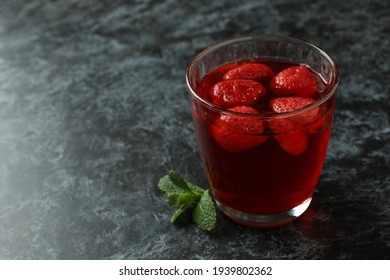 Glass of strawberry jelly on black smokey table