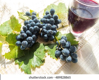 glass with stum and grapes