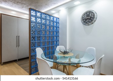 Glass table and white modern chairs in dining room interior