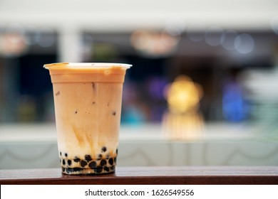 A glass of takeaway bubble milk tea with blurred background with space for word or textures