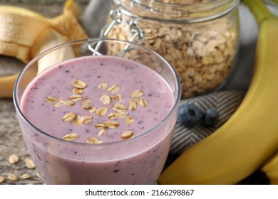 Glass Of Tasty Banana Blueberry Smoothie With Oatmeal On Table, Closeup