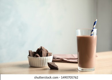 Glass Of Tasty Chocolate Milk On Wooden Table, Space For Text. Dairy Drink