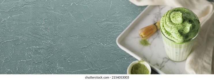 Glass Of Tasty Dalgona Matcha Latte On Grunge Background With Space For Text