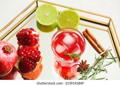 Glass Of Tasty Pomegranate Cocktail And Fruits On Table