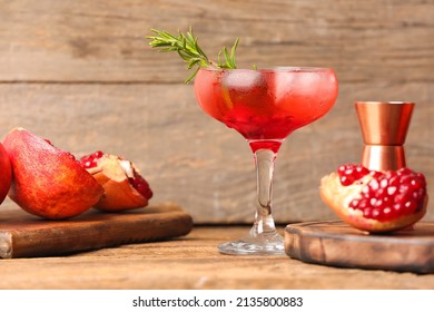 Glass Of Tasty Pomegranate Cocktail On Wooden Background