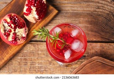 Glass Of Tasty Pomegranate Cocktail On Wooden Background