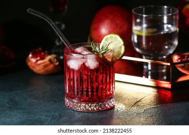 Glass Of Tasty Pomegranate Cocktail On Black Background