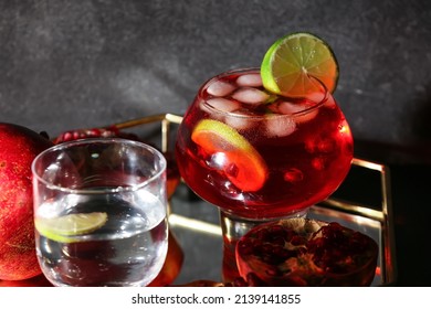 Glass Of Tasty Pomegranate Cocktail On Black Background