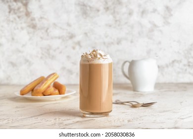 Glass of tasty Tiramisu Latte on light background - Shutterstock ID 2058030836