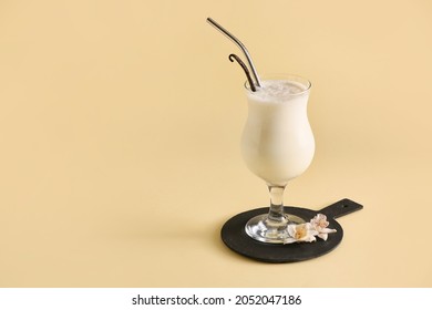 Glass with tasty vanilla milkshake on color background