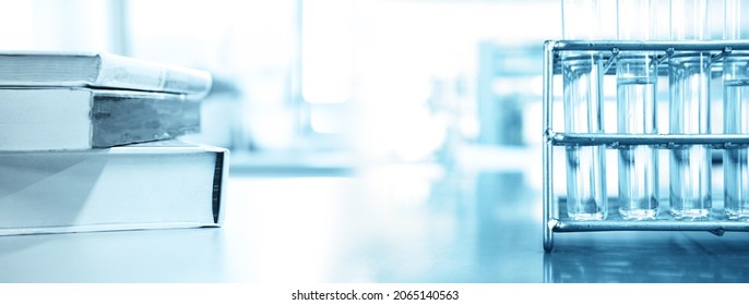 Glass Test Tube In Metal Rack And Stack Of Book In Research Science Lab Banner Background	