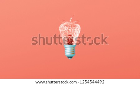 Glass textured strawberry lightbulb idea on creative Leaving Coral background. Concept of color of the year 2019. Minimal idea concept. Trendy pastel colors.