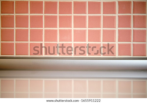 Glass tile background divided in half reflected\
in a mirror surface,\
texture