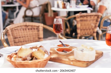A glass of traditional Portuguese sweet wine moscatel with cheese and bread in a cafe
