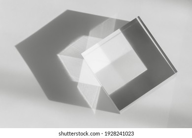 Glass Transparent Cube With Sun Reflection, Light And Shadow On White Background. Physics Refraction Effect, Translucent Prism. Decor For Flat Lay With Cosmetic Display, Abstract Background. Top View