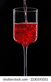 A glass with transparent red sparkling drink isolated on a black background with outline - Shutterstock ID 2230193331