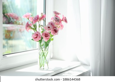 Glass vase with beautiful flowers on window sill in room, space for text - Powered by Shutterstock