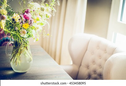Glass Vase With  Wild Field Flowers Bunch On Dinning Table With Chair At Window. Floral Home Decoration