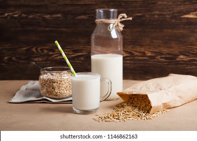 glass of  vegan oat milk and Oat on a table, space for text. 
