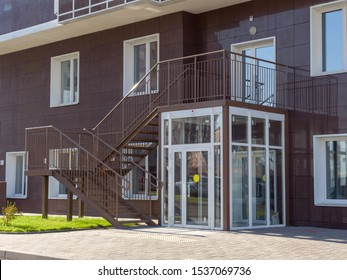 Glass Vestibule Entrance To A Residential Building. The Theme Of An Emerging Housing Market Under Construction