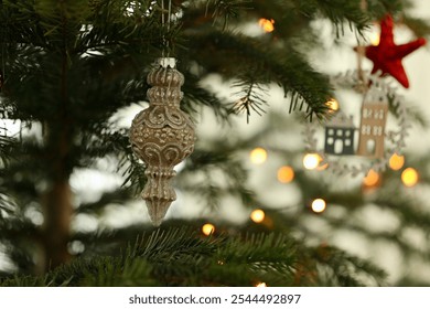 Glass vintage Christmas tree decoration hanging on Christmas tree. Christmas tree decoration with ornament close-up.                               