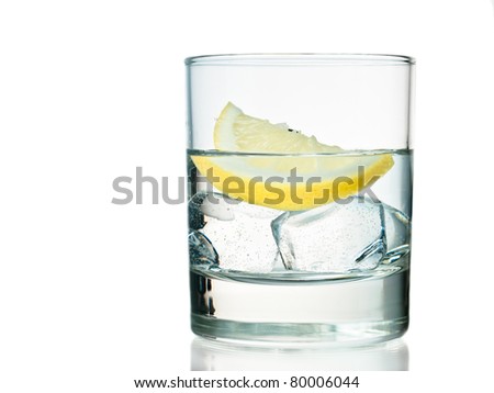 Glass of vodka on the rocks with lemon