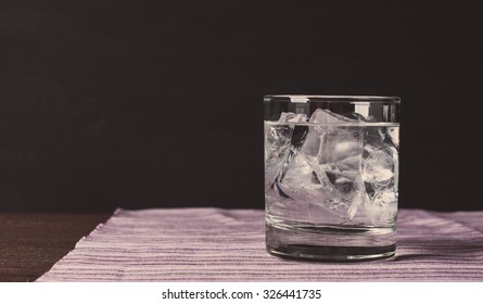 Glass Of Vodka On The Rocks. Vintage Style. Toned Image.