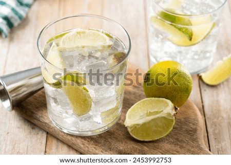 Glass of vodka tonic cocktail on wooden table