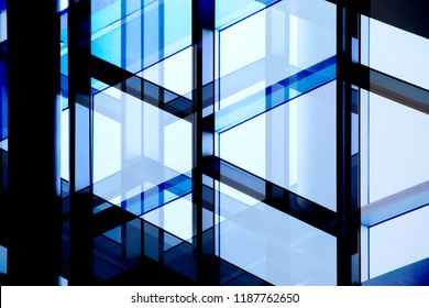 Glass wall with steel or aluminum framework. Structural glazing. Reworked close-up photo of office building fragment in shadows against clear blue sky. Abstract modern architecture background. - Shutterstock ID 1187762650