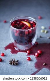 Glass Of Warm Mulled Wine With Cranberries On Tabletop In Kitchen