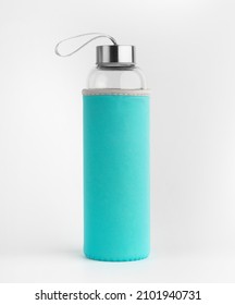 Glass water bottle with green protective case. Isolated on a white background. 