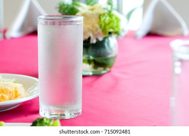 A Glass Of Water With  With Condensation On The Table.