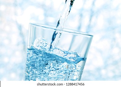 glass of water. glass cup of mineral water with bubbles on a winter blue background in the mountains. healthy lifestyle. sport. pure water. healthy food. melt water of mountain peaks and ice. spring