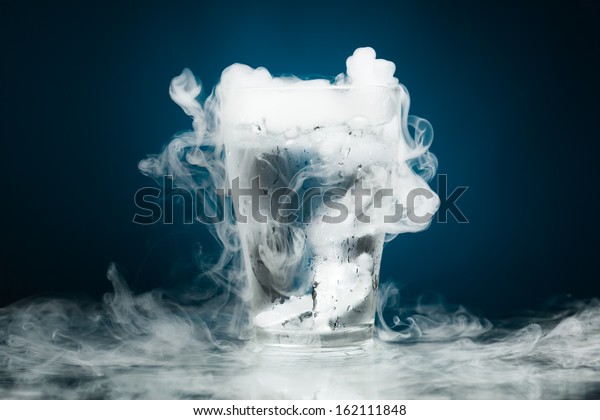 glass of water\
with ice vapor, blue\
background