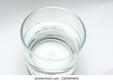 Glass Of Water Isolated On White Background. Half Full Half Empty Concept. 